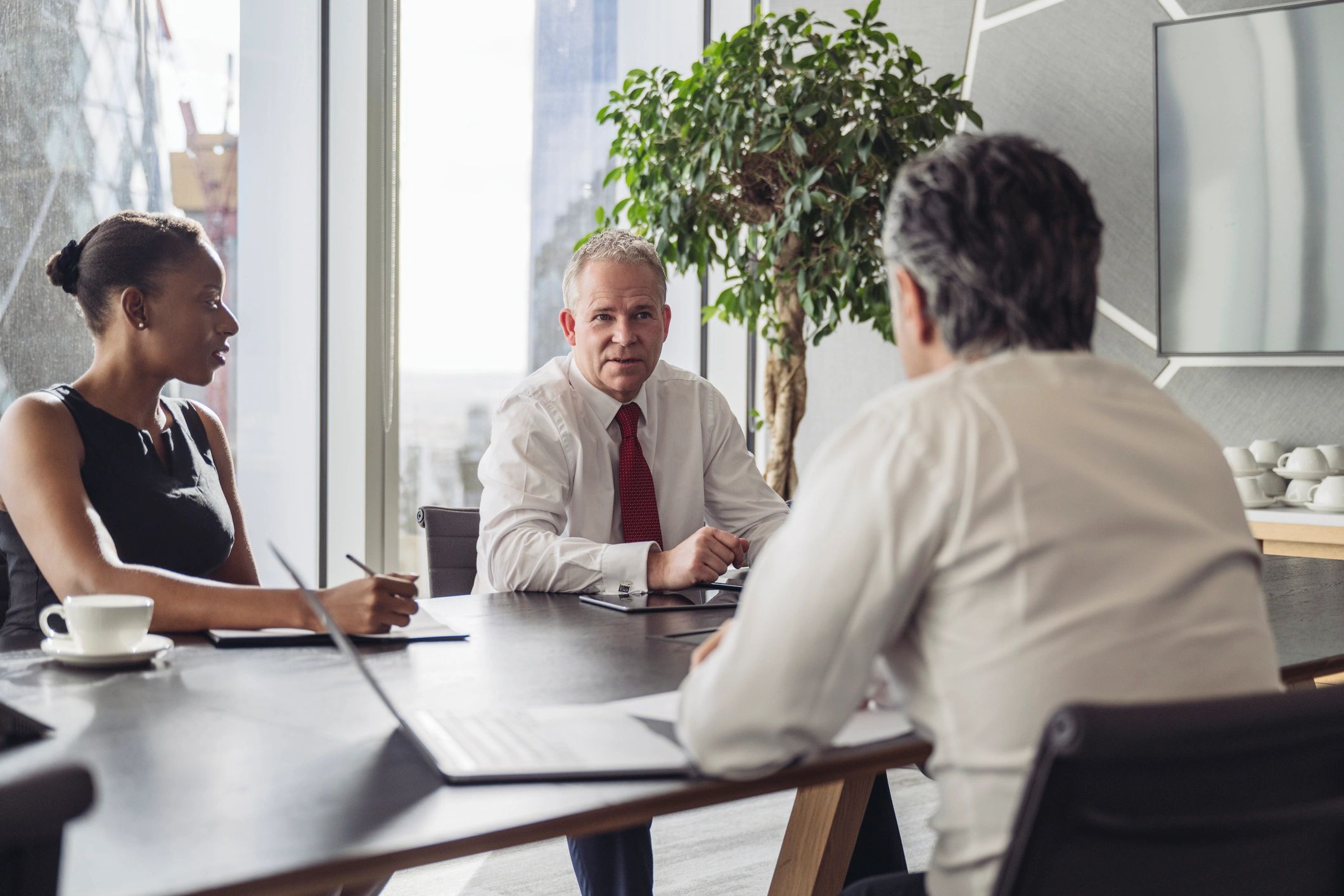 Corporate team discussing plans in a modern board room