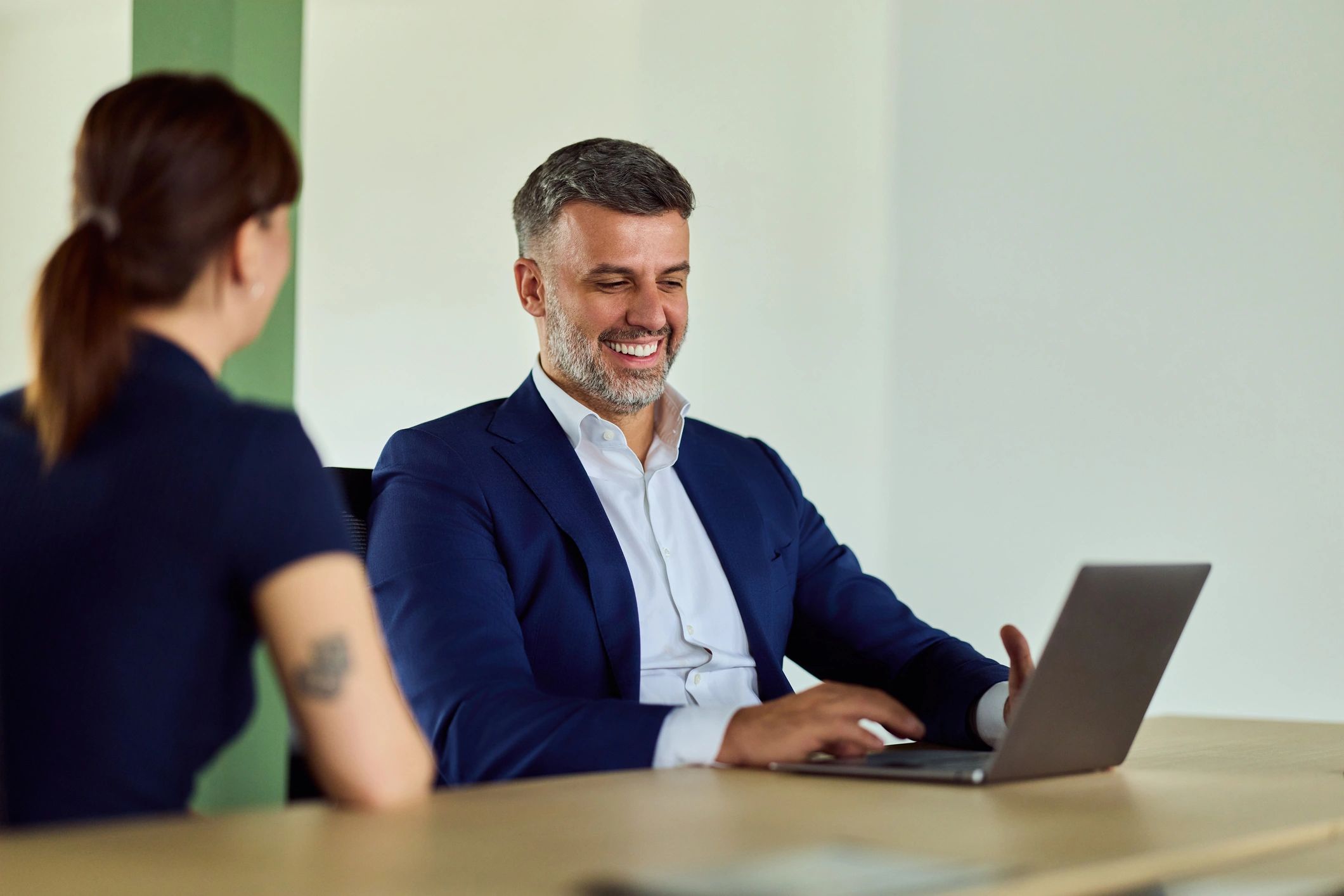 Professional business consultant in blue suit working during an office meeting